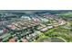 Overhead aerial view of a neighborhood situated next to a tranquil lake and wetlands offering picturesque scenery at 5368 Oakbourne Ave, Davenport, FL 33837