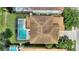 Aerial view highlighting a home with a screened pool enclosure in a well-maintained backyard at 5368 Oakbourne Ave, Davenport, FL 33837