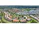 Expansive aerial view of the neighborhood positioned near a pond, green space, and other community homes at 5368 Oakbourne Ave, Davenport, FL 33837