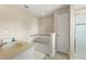 Bright bathroom features a soaking tub with decorative tile and a separate shower at 5368 Oakbourne Ave, Davenport, FL 33837