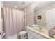 Standard bathroom featuring a shower/tub combo, a sink, and decorative accents at 5368 Oakbourne Ave, Davenport, FL 33837