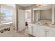 Bathroom with double sink vanity, stylish tile flooring, and an open door to the bedroom at 5368 Oakbourne Ave, Davenport, FL 33837