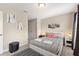 Bedroom with patterned rug, comfortable ottoman and modern decorative touches at 5368 Oakbourne Ave, Davenport, FL 33837