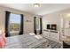 Well-lit bedroom features a large window and minimalist decor at 5368 Oakbourne Ave, Davenport, FL 33837
