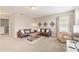 Comfortable bonus room features plush carpeting, a sofa, and a window for natural light at 5368 Oakbourne Ave, Davenport, FL 33837