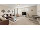 Well-lit bonus room featuring comfortable seating, neutral carpeting, and decorative wall art at 5368 Oakbourne Ave, Davenport, FL 33837