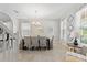 Elegant dining room featuring a modern chandelier, stylish furniture, and natural light at 5368 Oakbourne Ave, Davenport, FL 33837