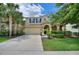 Inviting two-story home featuring a tile roof, manicured lawn, and an attached two-car garage at 5368 Oakbourne Ave, Davenport, FL 33837