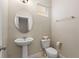 Traditional half bathroom with tile flooring, pedestal sink, and a decorative framed mirror at 5368 Oakbourne Ave, Davenport, FL 33837