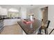 Bright kitchen featuring granite countertops, breakfast bar, stainless steel appliances, and tile flooring at 5368 Oakbourne Ave, Davenport, FL 33837