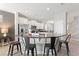 Kitchen with white cabinetry, stainless steel appliances, granite countertops and breakfast bar with seating for four at 5368 Oakbourne Ave, Davenport, FL 33837