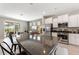 Open kitchen with stainless steel appliances, granite countertops and a breakfast bar overlooking the living area at 5368 Oakbourne Ave, Davenport, FL 33837