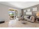 Living room with comfortable seating and sliding glass doors leading to a screened lanai with outdoor dining at 5368 Oakbourne Ave, Davenport, FL 33837