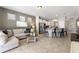 Open-concept living room connected to the kitchen featuring tile flooring and access to the screened patio at 5368 Oakbourne Ave, Davenport, FL 33837