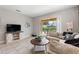 Cozy living room with comfortable seating, a stylish media center, and sliding glass doors to the outdoor pool area at 5368 Oakbourne Ave, Davenport, FL 33837