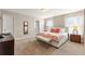 Main bedroom with plush carpeting, a king-size bed, and a stylish bench at 5368 Oakbourne Ave, Davenport, FL 33837