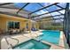 Spacious screened-in pool area with comfortable lounge chairs and an adjacent outdoor dining space at 5368 Oakbourne Ave, Davenport, FL 33837