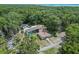 A spacious property featuring a home, pool, outbuildings, and ample greenery from above at 546 Winona Dr, Geneva, FL 32732