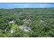 A wooded property offering a home and tennis court with waterfront access from above at 546 Winona Dr, Geneva, FL 32732