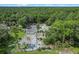 A wooded property showcases a tennis court bordered by a dense forest at 546 Winona Dr, Geneva, FL 32732