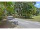 Gated driveway entrance with stone pillars, ensuring privacy and security for this property with lush landscaping at 546 Winona Dr, Geneva, FL 32732