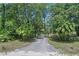 Gated driveway leading to the property, surrounded by trees at 546 Winona Dr, Geneva, FL 32732