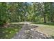 Long gravel driveway leading to a treed property at 546 Winona Dr, Geneva, FL 32732