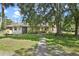 Inviting home with stone accents and a walkway leading to the front entrance at 546 Winona Dr, Geneva, FL 32732