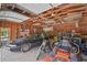 Open-beamed garage with multiple vehicles, tools and american flag at 546 Winona Dr, Geneva, FL 32732