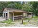Garage with covered area to the side, tools and ladder in side area at 546 Winona Dr, Geneva, FL 32732