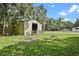 Exterior view of an outbuilding with a roll up door, offering storage space and functionality on the property at 546 Winona Dr, Geneva, FL 32732