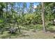 Relaxing pond with lily pads and swing, creating a peaceful backyard oasis surrounded by natural beauty at 546 Winona Dr, Geneva, FL 32732