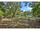 Large property featuring a wooded area with a tennis court and mature trees at 546 Winona Dr, Geneva, FL 32732