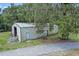 Exterior angle of metal shed, surrounded by trees and greenery at 546 Winona Dr, Geneva, FL 32732