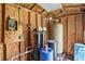 Well-maintained utility room with electrical panel, water tanks, and other mechanical components in a wooden structure at 546 Winona Dr, Geneva, FL 32732