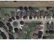 An aerial view shows a community with well-maintained lawns, mature trees, and a circular street design at 5917 Coquyt Dr, Mount Dora, FL 32757