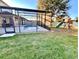 Backyard with a pool, screened in enclosure, outdoor playset, and green grass at 5917 Coquyt Dr, Mount Dora, FL 32757