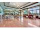 A spacious ballroom with hardwood floors, large windows, and elegant seating arrangements at 5917 Coquyt Dr, Mount Dora, FL 32757