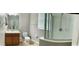 Bathroom with vanity, toilet, towel rack, mirror, and shower with glass door and neutral wall color at 5917 Coquyt Dr, Mount Dora, FL 32757