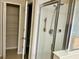 Bathroom featuring shower with glass door, storage shelves and neutral colored walls at 5917 Coquyt Dr, Mount Dora, FL 32757