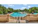 A grand staircase leads to the community pool, surrounded by lush greenery and lounge chairs at 5917 Coquyt Dr, Mount Dora, FL 32757