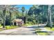 Community entry gate with desert landscaping and view of the quiet, well-maintained street at 5917 Coquyt Dr, Mount Dora, FL 32757
