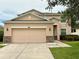 Charming two-story home with a two-car garage and manicured lawn at 5917 Coquyt Dr, Mount Dora, FL 32757