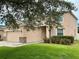 Side view of a charming two-story home with a well-maintained lawn at 5917 Coquyt Dr, Mount Dora, FL 32757