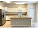 Bright kitchen with an island, granite countertops, and white cabinetry at 5917 Coquyt Dr, Mount Dora, FL 32757