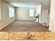 Spacious living room with neutral carpet, plenty of natural light, and view of the kitchen island at 5917 Coquyt Dr, Mount Dora, FL 32757