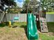 Backyard wooden playset featuring a slide and swings at 5917 Coquyt Dr, Mount Dora, FL 32757