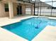 Inviting pool with a screened-in enclosure and spacious patio area at 5917 Coquyt Dr, Mount Dora, FL 32757