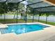 Screened in pool with clear blue water and outdoor playset at 5917 Coquyt Dr, Mount Dora, FL 32757