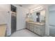 Bathroom featuring double vanity, a framed mirror, and glass-enclosed shower at 5990 Se 5Th Pl, Ocala, FL 34472